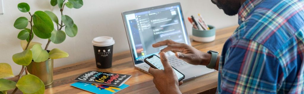 a man holding a phone while working