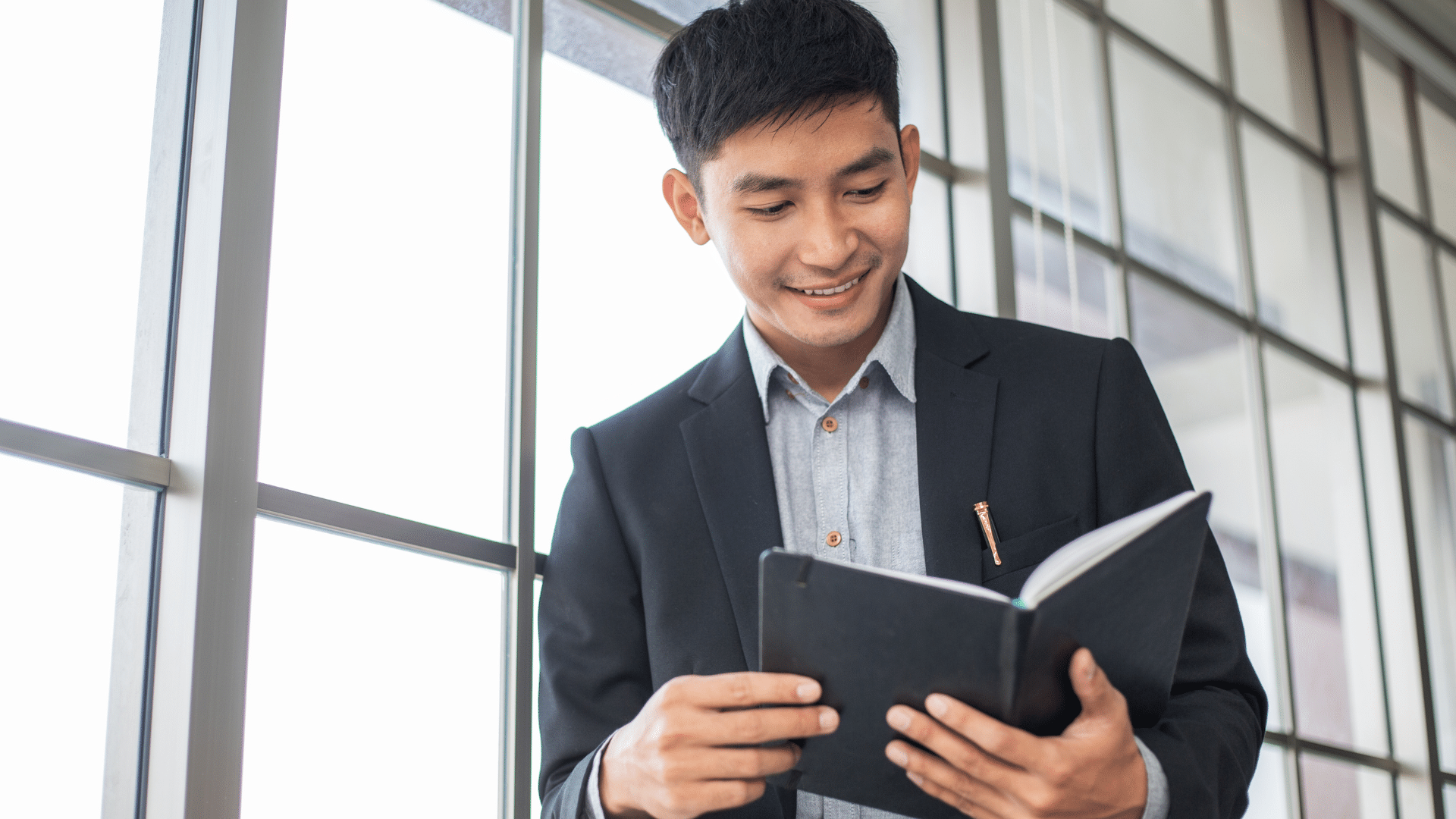 man looking at his book